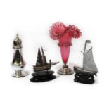 A silver sugar sifter, cranberry vase, and two eastern model boats. Tallest item 17cm