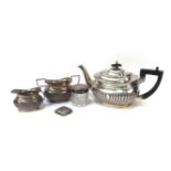 A silver three piece tea set by Harrison Fisher & Co, Sheffield 1927, a silver Vesta case, and a