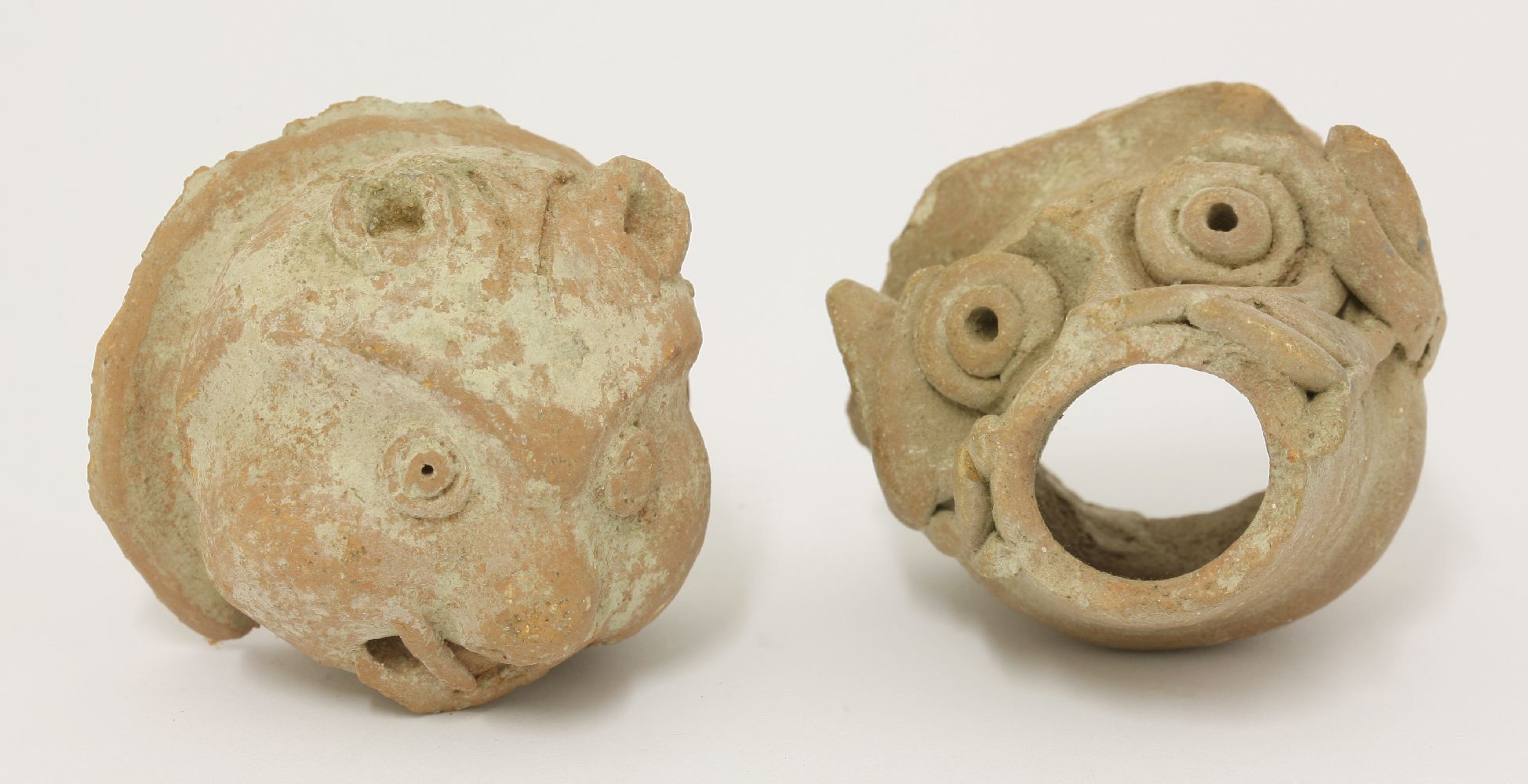 Two South-Indian terracotta mask heads, 19th century, in the form of a monkey and a pig,5.5 and