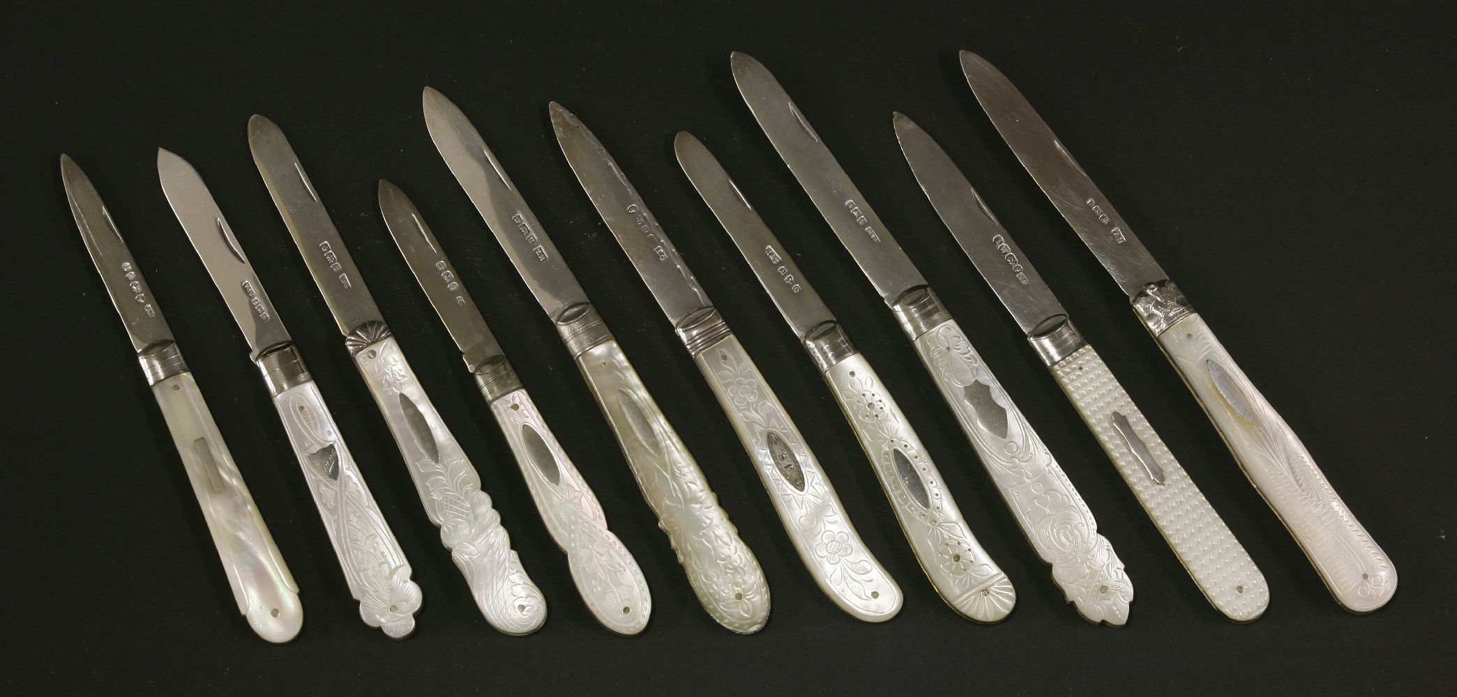 Ten Victorian and later silver and mother-of-pearl folding fruit knives,one marked H&T, Chester,each