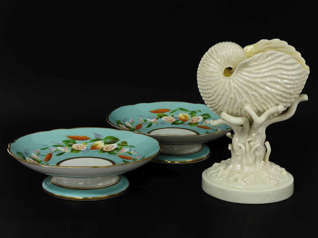 A Belleek nautilus shell centrepiece, stamped Belleek Co. Fermanagh, with a black mark, 21.5cm
