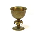 An early 20th century bronze and gilt metal chalice, the circular bowl on a knapped stem with