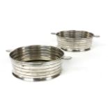 A pair of Electroplated nickel Art Deco disheswith moulded bands and art deco motif handles diameter