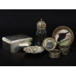 A hallmarked silver cigarette box, a continental silver scallop form dish and a small collection
