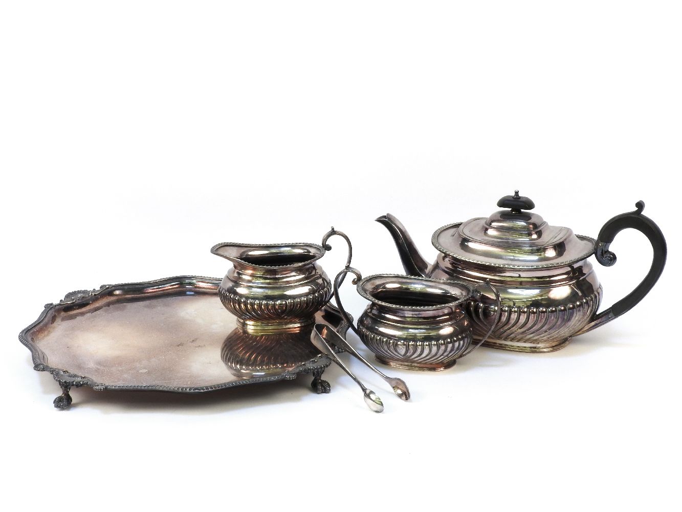 A silver plated three piece tea set, with half reeded ovoid body and gadrooned border, together with