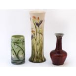 Three Cobridge pottery vases, a snow drop vase, 12.5cm, a flambe vase, 15cm high, and a tall