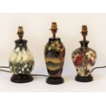 Three Moorcroft pottery lamp bases, all lacking shades, tallest 31cm to top of fitting (3)