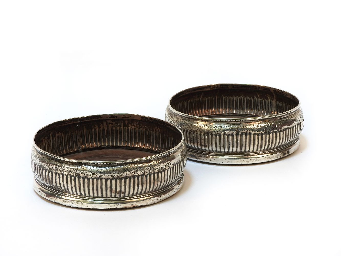 A pair of Victorian silver wine coasters, hallmarked for Sheffield 1848, makers marks rubbed