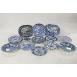 A quantity of 18th/19th century blue and white transfer printed pottery plates, largely botanical
