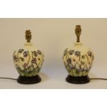 A pair of Moorcroft lamp bases, ebonised plinths, no shades