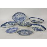 A quantity of various early 19th century blue and white navette shaped dishes, and stands, decorated
