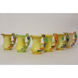 Six Burleigh ware jugs, each with a parrot handle, various colourways, tallest 20cm high
