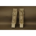 A pair of carved marble elements in the form of angels, with heads bowed, each approximately 66cm