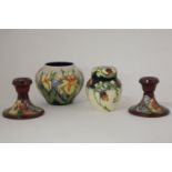 A pair of Moorcroft dwarf candlesticks, a vase and a ginger jar, 11cm highest (3)