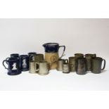 A collection of pewter and stoneware tankards