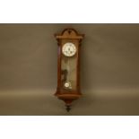 A walnut Vienna wall clock, with key and pendulum