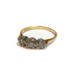 An 18ct gold three stone illusion set diamond ring, 3.23g