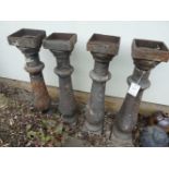 Four cast iron balusters, each 94cm tall (4)