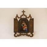 A porcelain icon possibly KPM depicting a panel of The Madonna and child in a gilt/plated stand,