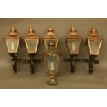 A set of five copper lanterns, and another similar with wrought iron brackets