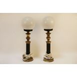 A pair of brass and ebonised table lamps, with globular milk glass shades