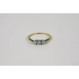 A gold three stone diamond ring, marked 18ct and Plat