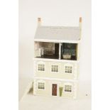 A three storey Tudor style doll's town house, with fitted interior and many contents and another