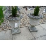 Four small reconstituted stone garden urns, planted with conifers, urns 44cm high (4)