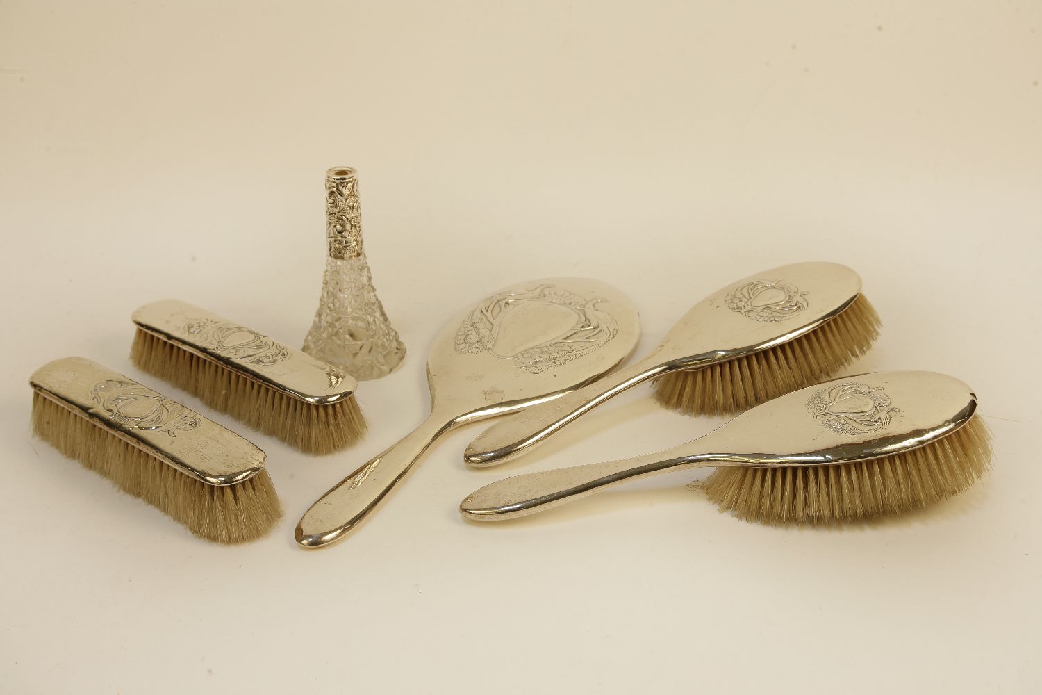 A silver backed dressing table set, and a silver topped scent bottle