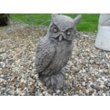 A figure of a long eared owl in cast stone, 51cm high