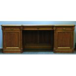 A Victorian oak inverted front sideboard, raised on twin pedestals, with linen fold panelled fronts