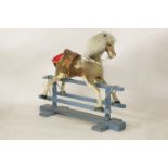 A hide upholstered small rocking horse 110cm long