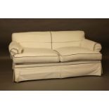 A contemporary cream upholstered two seater settee, on short legs, 64 x 99cm