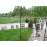 A pair of hand forged wrought iron triangular garden obelisks, with scrolled finials, 229cm high x