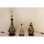 Three Moorcroft lamp bases, one lacking shade, 34cm tallest