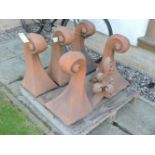 Six terracotta roof finials of scrolling form, 53cm high