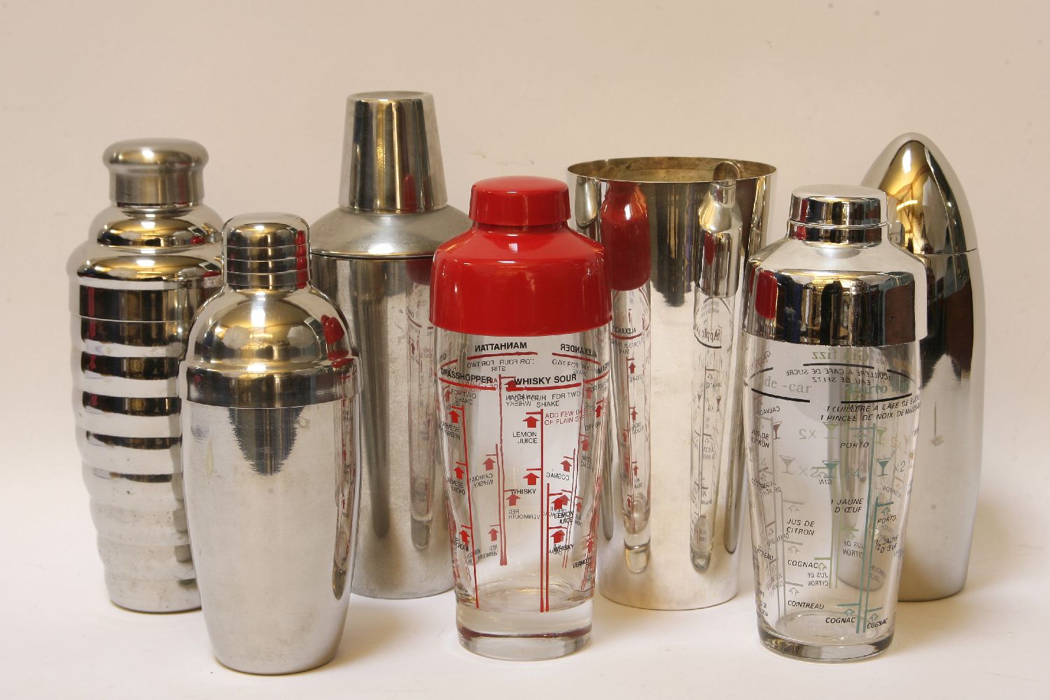 Six vintage cocktail shakers, and a mixer, with spoon