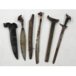Three Malay Kris, probably early 20th century, each with wood or bone handles, steel blades,