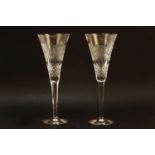 A pair of Waterford oversized champagne glasses, the conical bowls with hobnail cut detailing on a