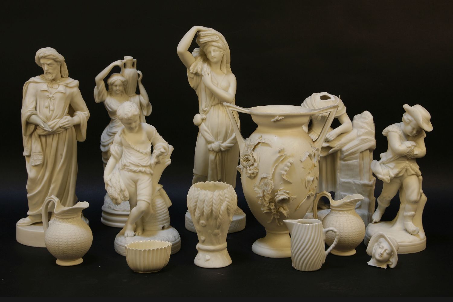 Four Parian figures, two restored, one damaged, and other Parian ware jugs