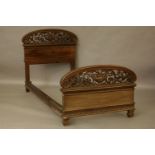 A 19th century Continental carved walnut single bedstead, with scrolling leaf decoration