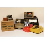 A collection of camera equipment, original lighting and reel, including a Polaroid