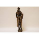 An African hardwood carved figure of a tribesman with shield