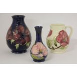 A Moorcroft Anemone, 1994, second, 19cm high, and another vase, 16cm high, and a jug, 1994, second