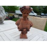 A terracotta cast bust of a young girl in Art Nouveau style, with flowers in her hair, 46cm high x