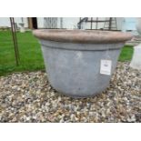 A large circular faux stone planter, 71cm diameter x 46cm high