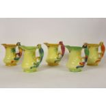 Five Burleigh ware jugs, each with a parrot handle, various colourways