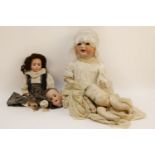 A Simon & Halbig number 126 porcelain headed doll, together with two other porcelain headed dolls (