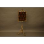 A Victorian gilt pole firescreen with tapestry panel on tripod base, 161cm high