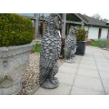 A pair of very large cast stone mythical owls, 37cm wide x 30.5cm deep x 104cm high